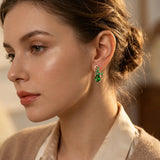 Boucles d'oreilles pendantes en or et émeraudes